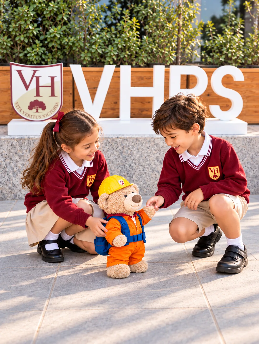 Children greet Basil at the school gate
